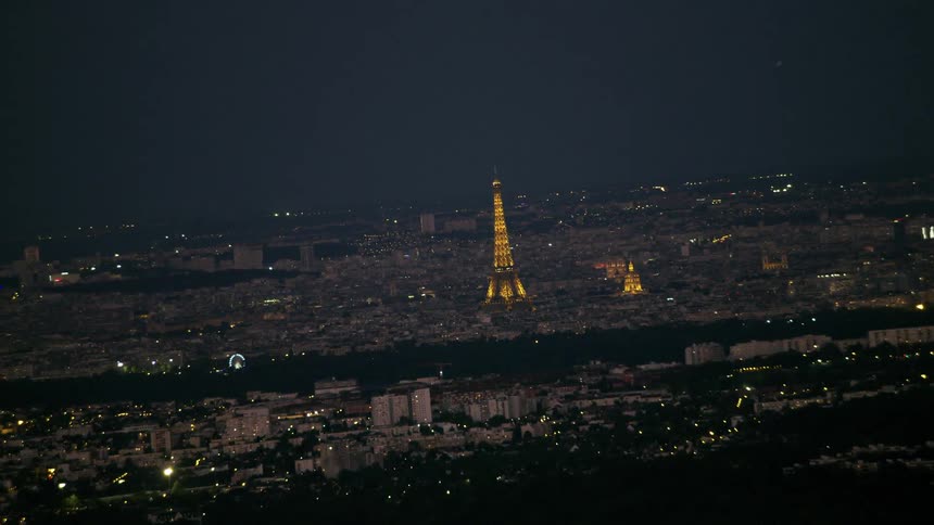 The eiffel tower glows in the night