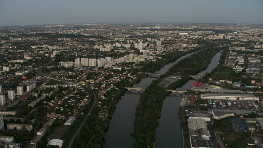 Bridges span a canal of a large coastal city