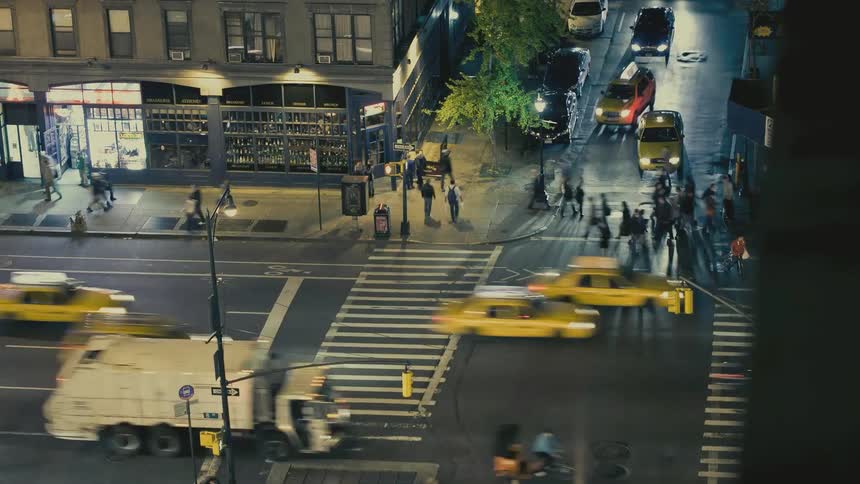 Time lapse footage of a busy NYC intersection at night