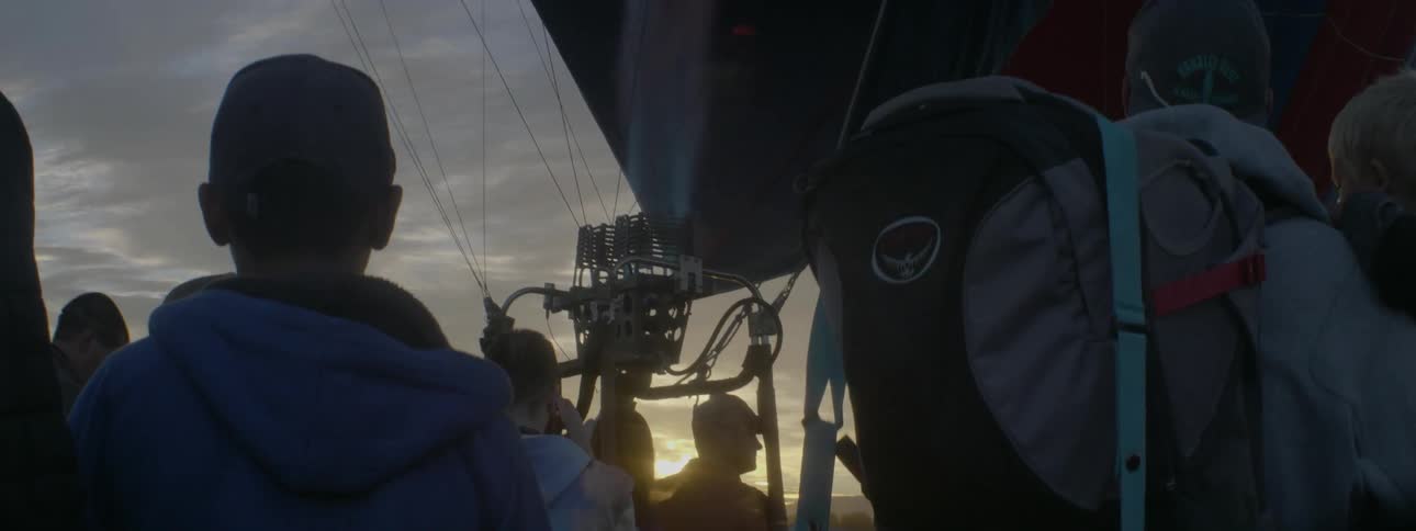 People ride in a hot air balloon