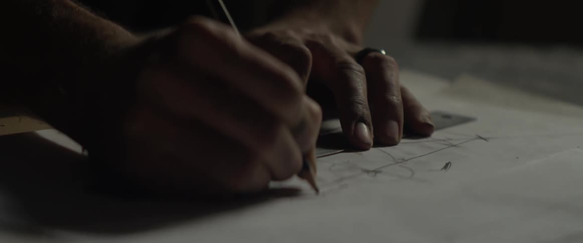 Man makes a sketch with a ruler and pencil