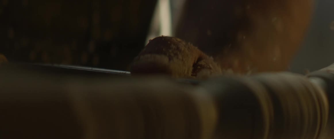 Carpenter shapes a spinning piece of wood