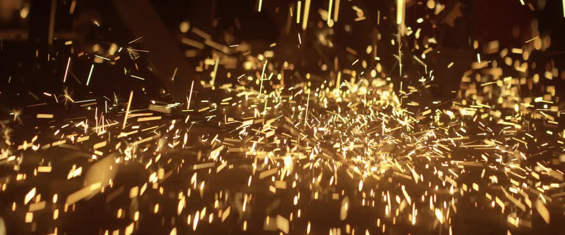 Sparks fall to the ground near a table