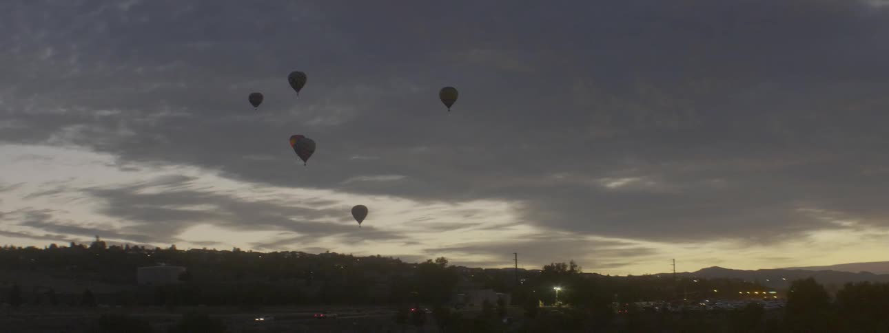 Hot air balloons floating at sunset
