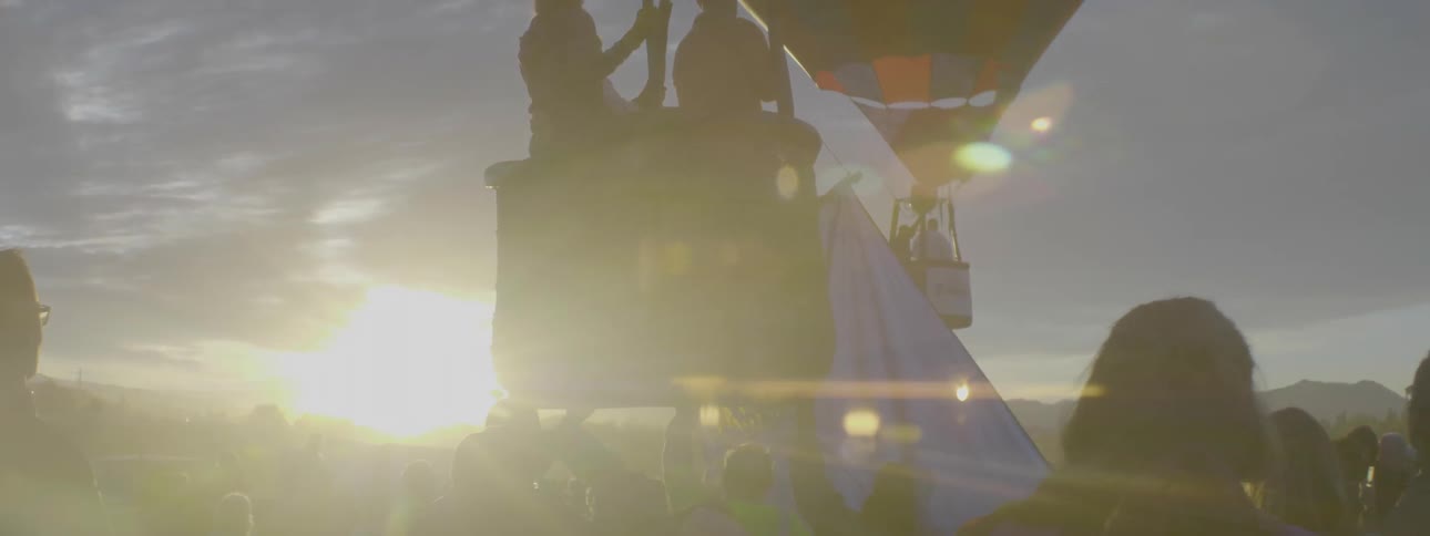 People flying away on a hot air balloon