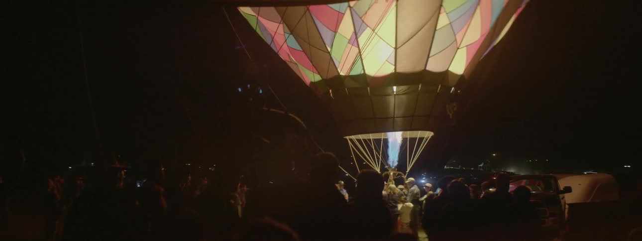 People stand near a filling hot air balloon