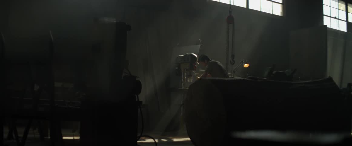 A carpenter works in a shop