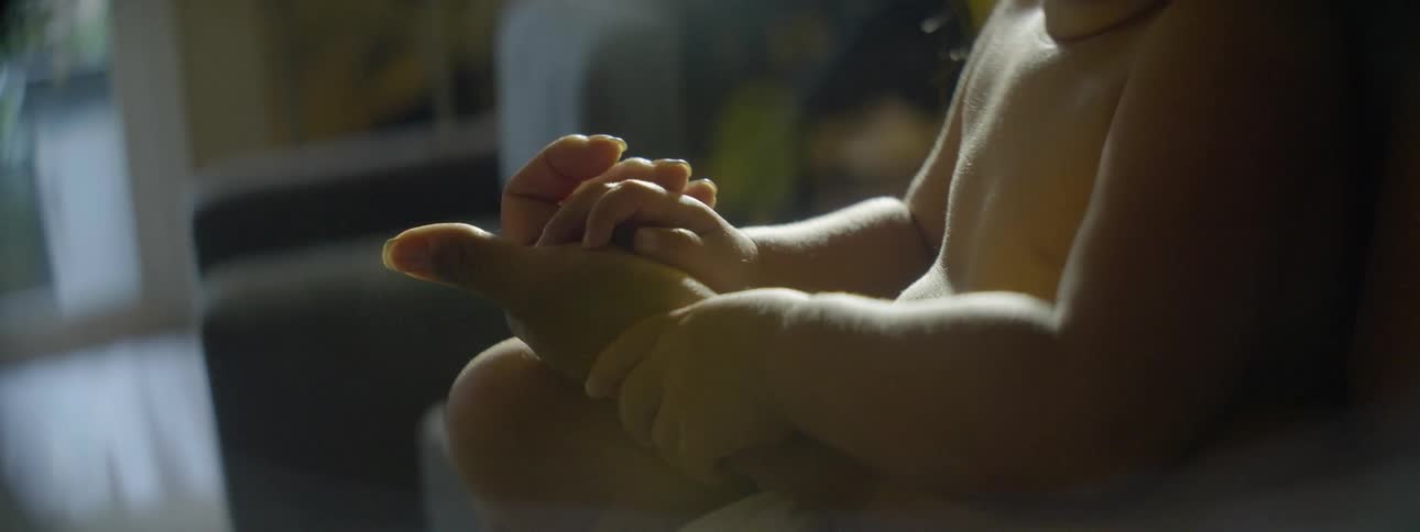 A baby is being held in someone's lap