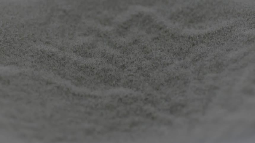 Sand is vibrating and sifting down in abstract