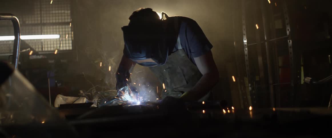 A man welds in a workshop