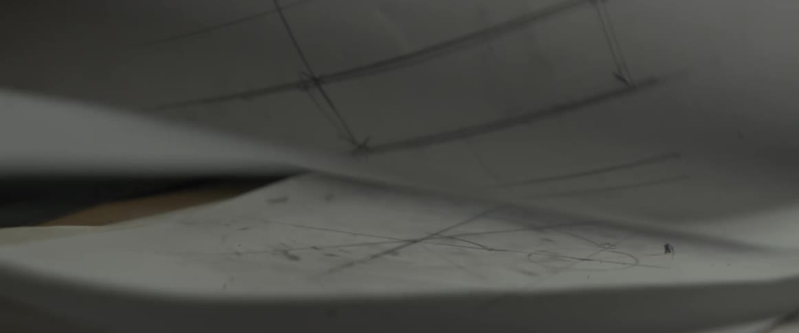 A man browses blueprints on a table
