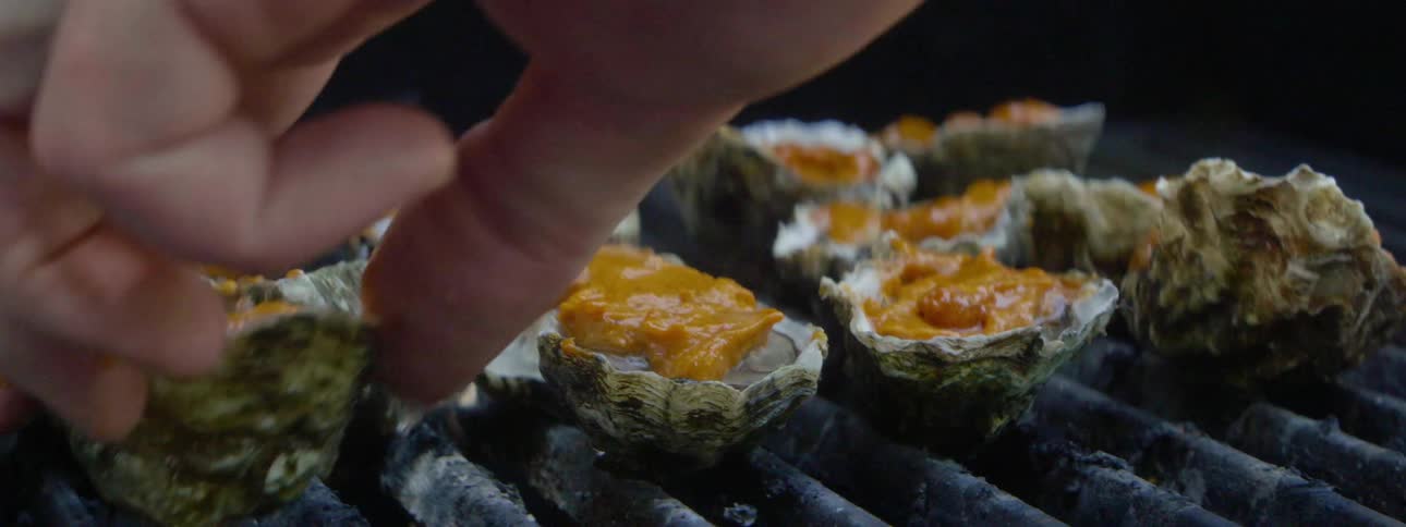 Oysters are placed on grill grates