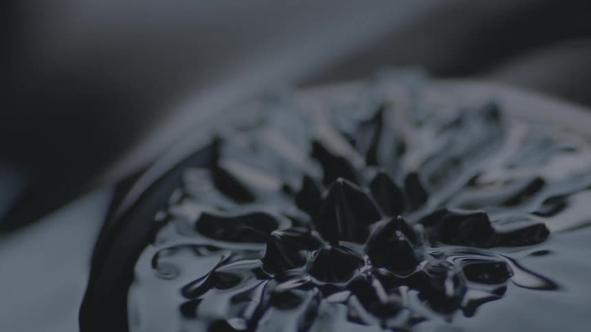 Black liquid ripples up into a spiked pattern