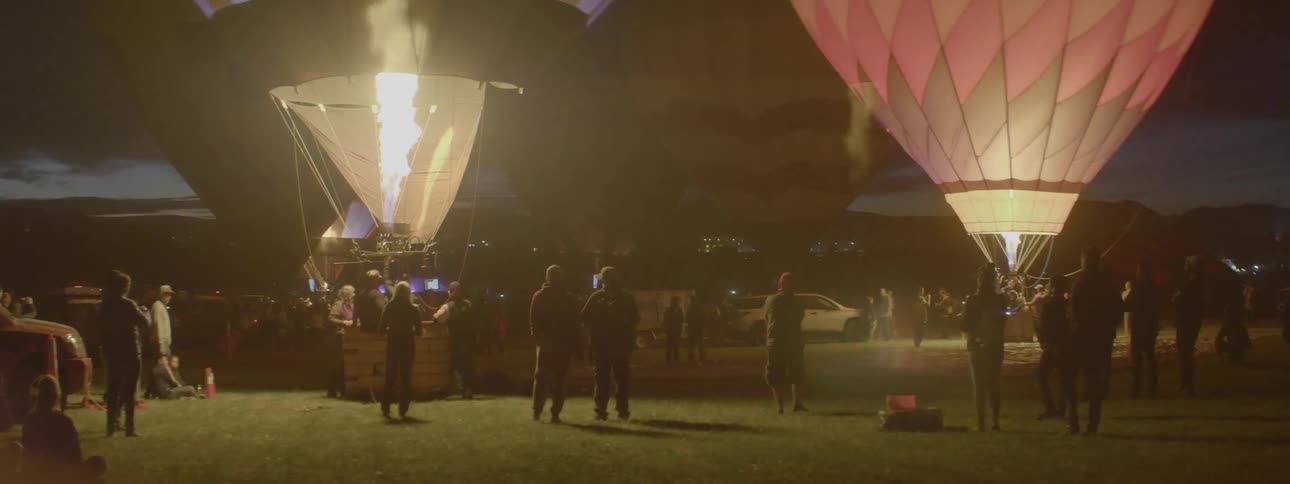 The hot air balloons light up the night sky