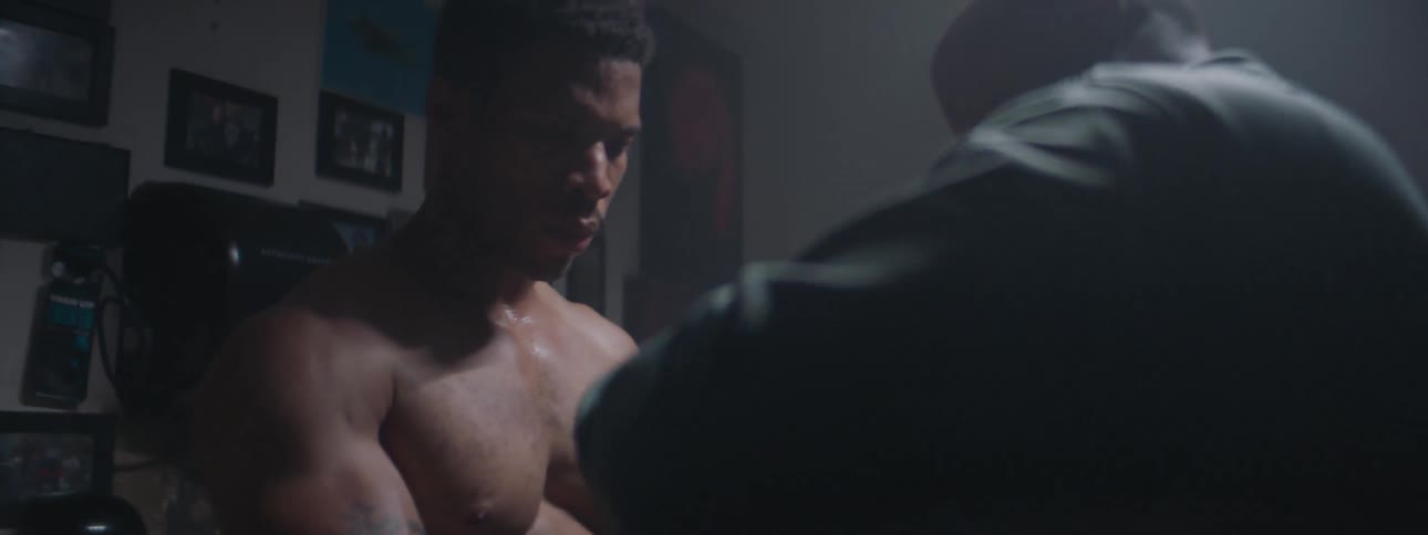 A boxing couch is helping put a boxers gloves on