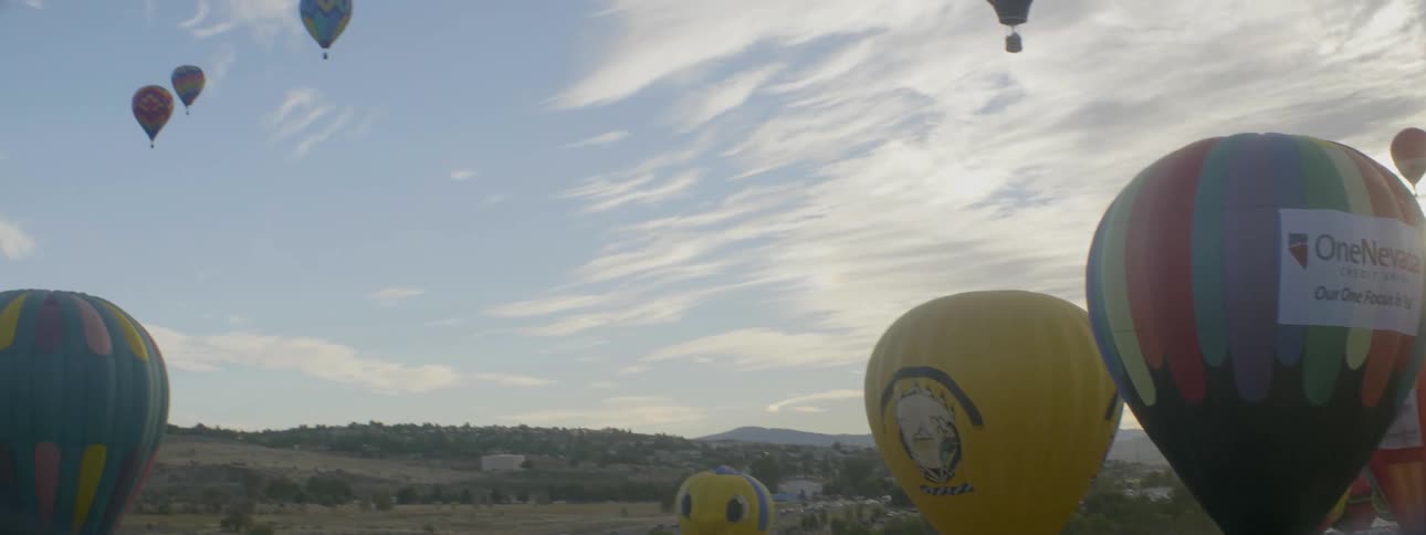 Hot air balloons are lifting off at dawn