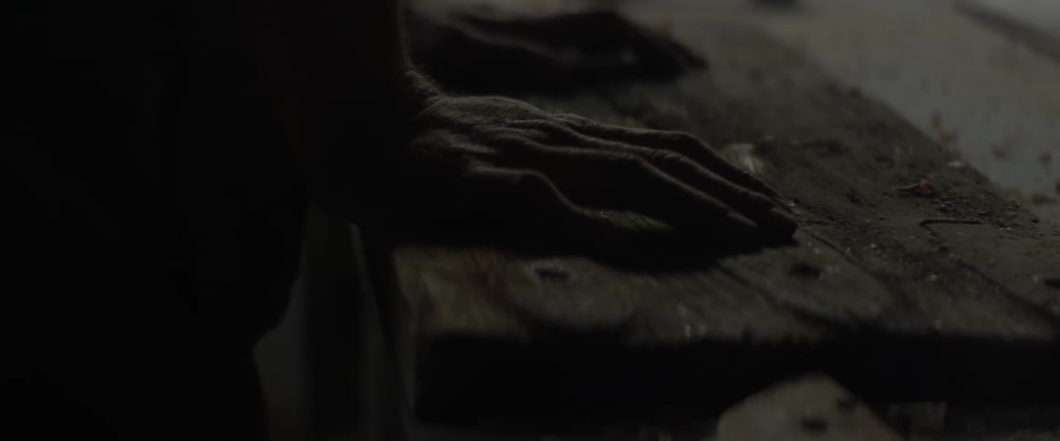 A man is placing his hands on a wooden chest