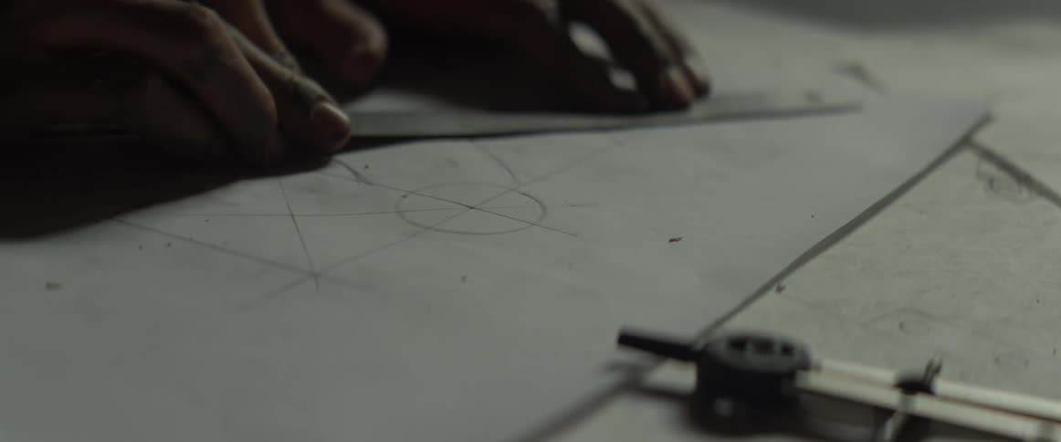 A person is using a ruler to draw lines