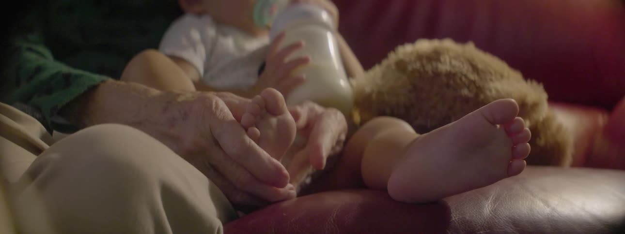 A man rubs a baby's foot