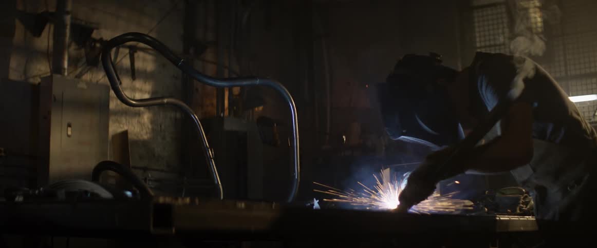 Sparks fly from a person welding