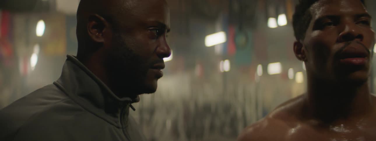Two men talking in a gym