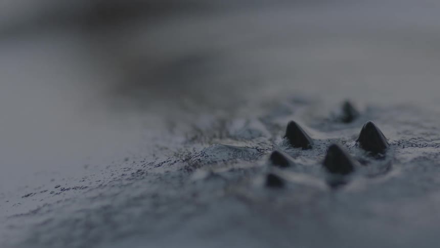 A liquified substance oozes and forms cones in abstract