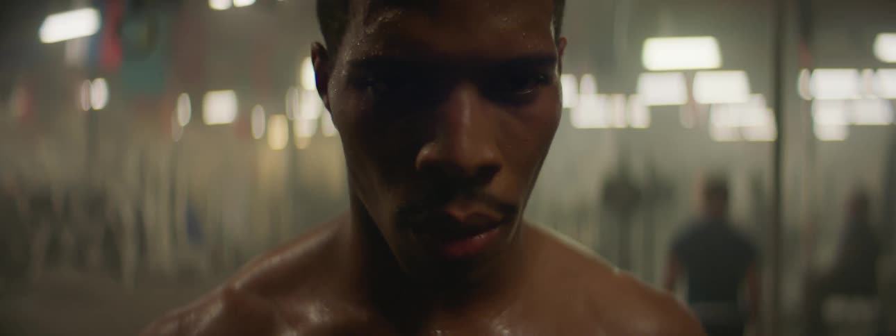 A man is sweating exercising in a gym
