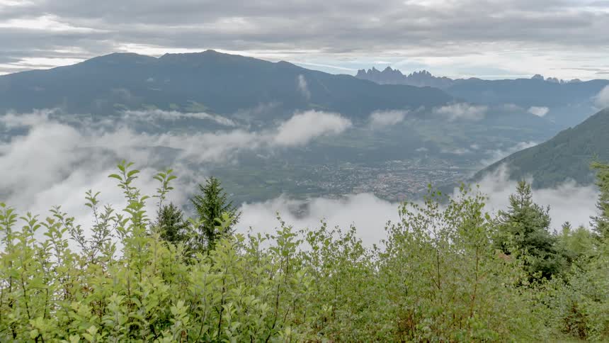 Time lapse of clouds floating around a cliff side