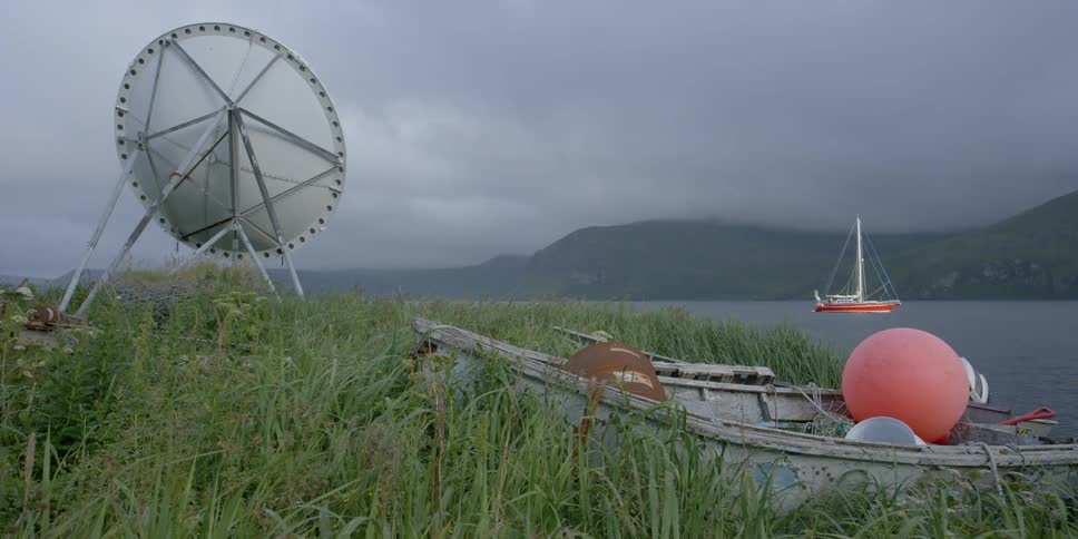 A boat sails on the ocean on a cloudy day