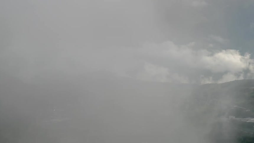 Time lapse of clouds swirling around a valley