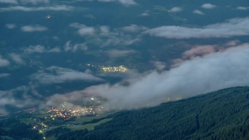Clouds rolling over a valley city