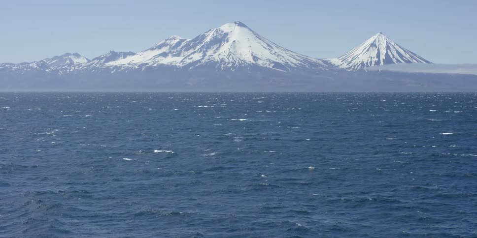 Snow capped mountains near the ocean