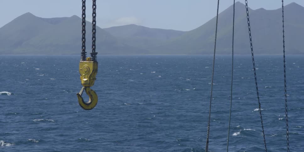 A hook is hanging and swaying in the wind
