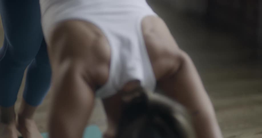 A woman stretches in front of a window