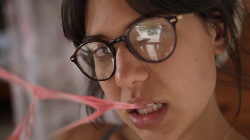 Woman plays with her bubble gum
