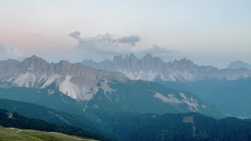 Clouds pass above a mountain and the valley