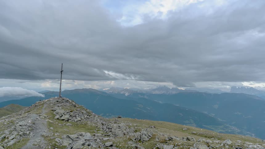 A cross sits atop a mountain