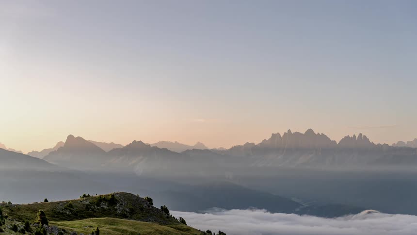 Time lapse of clouds forming in a valley below a mountain