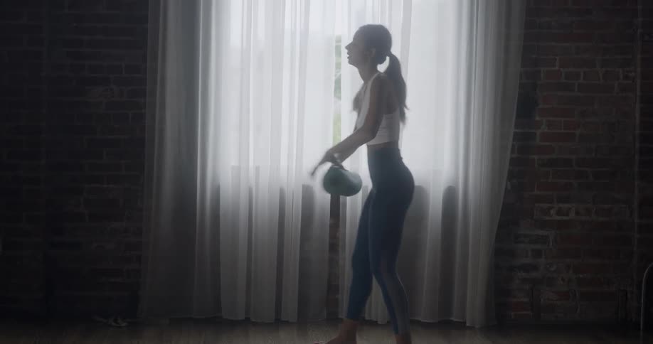 A woman unrolls her yoga mat