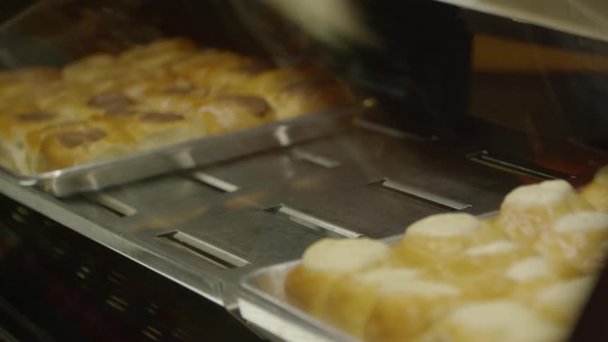 Cinnamon rolls cover a baking sheet