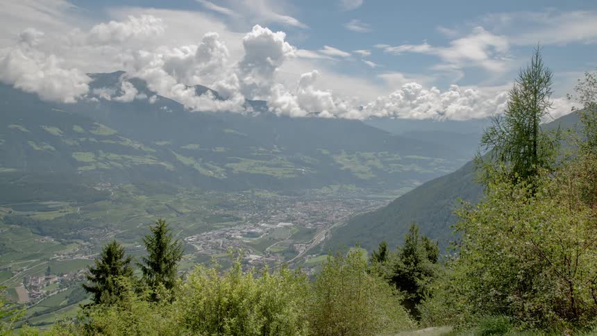 Clouds float over a mountain valley