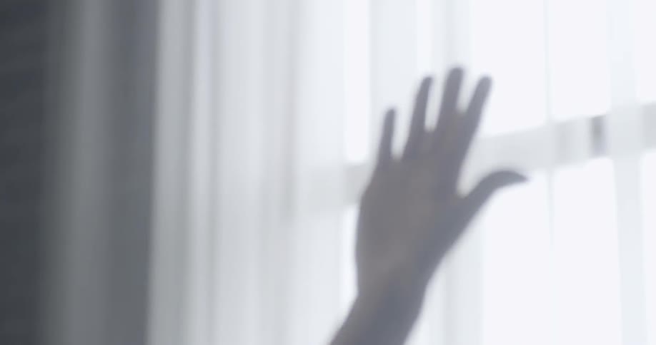 A woman is stretching inside of an apartment building