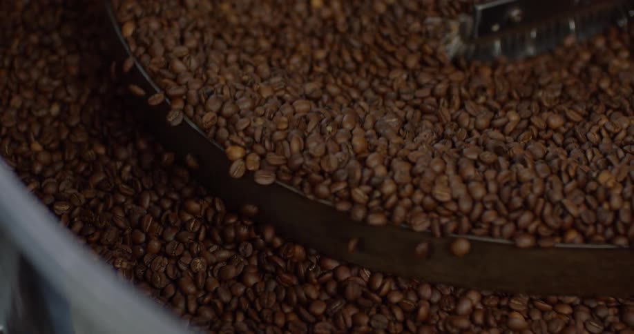 Coffee beans are cooked in a roaster