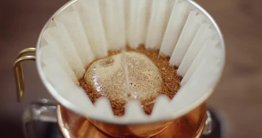 The filter full of coffee is soon covered with liquid
