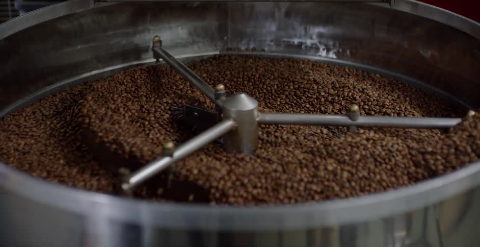 Coffee beans being stirred in a machine