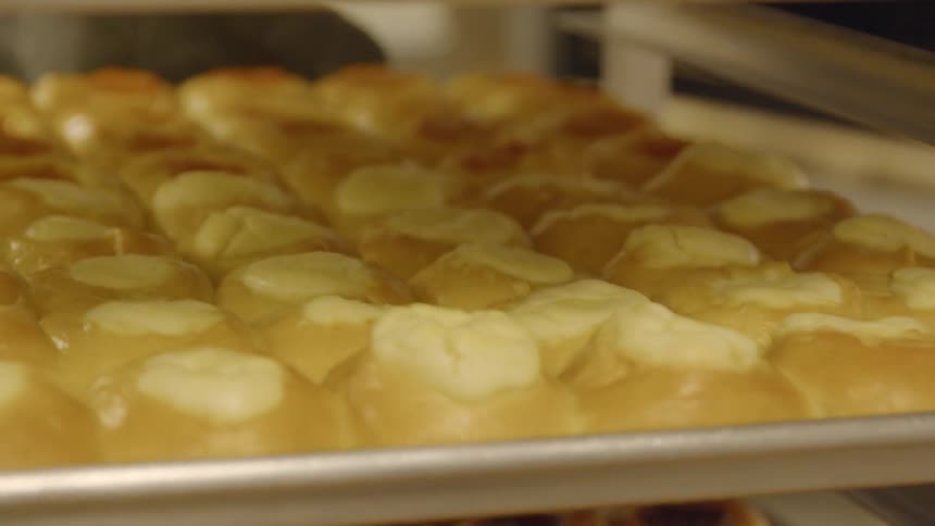 The pastries are sitting on the pans