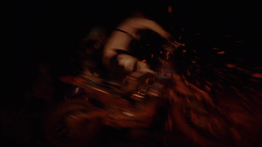 People racing dirt bikes at night