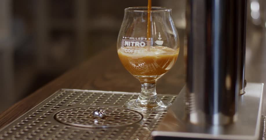 A coffee drink is poured into a glass