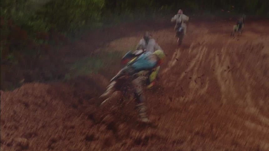Motocross riders ride on a dirt course