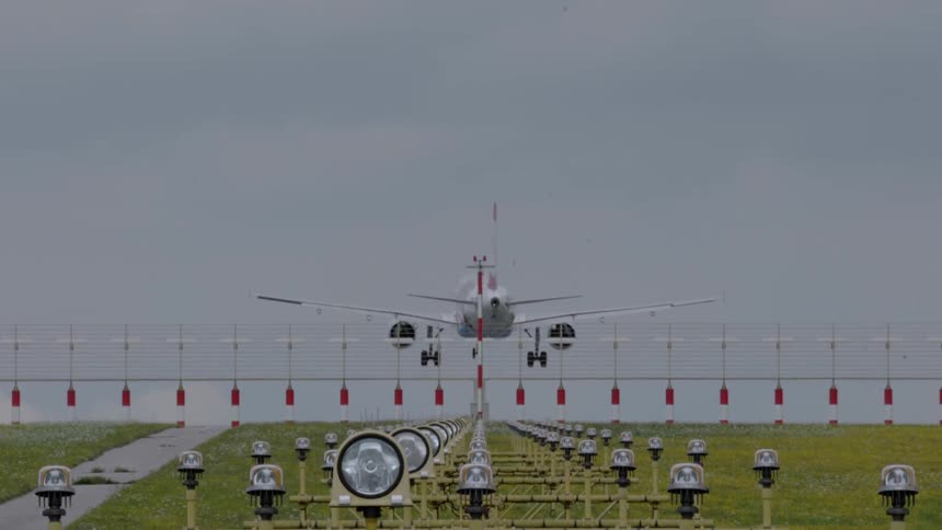A plane flies over a field of lights